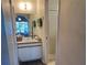 Well-lit bathroom with a walk-in shower at 25068 Harborview Rd # 3D, Punta Gorda, FL 33980