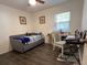 Cozy bedroom featuring a daybed and workspace by the bright window at 25068 Harborview Rd # 3D, Punta Gorda, FL 33980