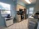 Bright kitchen with stainless steel refrigerator and neutral counters at 25068 Harborview Rd # 3D, Punta Gorda, FL 33980
