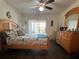 Comfortable bedroom with wood floors, a ceiling fan, and serene natural light creating a relaxing space at 25068 Harborview Rd # 3D, Punta Gorda, FL 33980