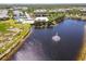 Overhead community view of a pond and the pool area with a white pergola at 25559 Heritage Lake Blvd # 25, Punta Gorda, FL 33983