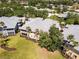 Aerial view of multi-Gathering condo building, showing exterior, screened patios, landscaping, and surrounding residences at 25559 Heritage Lake Blvd # 25, Punta Gorda, FL 33983