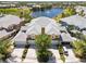Stunning aerial view of townhomes with a central water feature and beautiful landscaping at 25559 Heritage Lake Blvd # 25, Punta Gorda, FL 33983