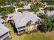 Scenic aerial view of a charming two-story building, enhanced by lush landscaping and swaying palm trees at 25559 Heritage Lake Blvd # 25, Punta Gorda, FL 33983