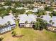 Aerial view of the rear of a condo surrounded by lush trees and landscaping in a residential neighborhood at 25559 Heritage Lake Blvd # 25, Punta Gorda, FL 33983