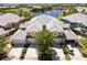 Aerial view of a community with a pond, pool, and manicured green spaces at 25559 Heritage Lake Blvd # 25, Punta Gorda, FL 33983
