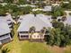 An aerial view captures a beautiful two-story building with a screened-in porch and a well-manicured lawn at 25559 Heritage Lake Blvd # 25, Punta Gorda, FL 33983