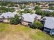 Overhead view of multi-Gathering residential building featuring well-maintained lawn, mature trees, and multiple balconies at 25559 Heritage Lake Blvd # 25, Punta Gorda, FL 33983