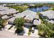 A scenic aerial view shows a townhouse community with a lake and pool area at 25559 Heritage Lake Blvd # 25, Punta Gorda, FL 33983