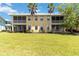 Spacious backyard with palm trees and a well-maintained lawn, offering great outdoor living at 25559 Heritage Lake Blvd # 25, Punta Gorda, FL 33983