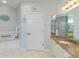 Bathroom with granite countertop vanity and a tub with shower at 25559 Heritage Lake Blvd # 25, Punta Gorda, FL 33983
