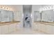 Dual vanities in a Primary bathroom with granite countertops, sinks and white cabinetry at 25559 Heritage Lake Blvd # 25, Punta Gorda, FL 33983