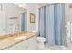 Clean bathroom with a shower curtain and granite counters at 25559 Heritage Lake Blvd # 25, Punta Gorda, FL 33983