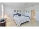 Bright bedroom with white walls, decorative art, and access to a hallway at 25559 Heritage Lake Blvd # 25, Punta Gorda, FL 33983