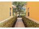 Quaint pathway between homes bordered by lush greenery, creating a private and inviting atmosphere at 25559 Heritage Lake Blvd # 25, Punta Gorda, FL 33983