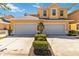Charming home with manicured bushes and an attached two-car garage, creating a welcoming curb appeal at 25559 Heritage Lake Blvd # 25, Punta Gorda, FL 33983
