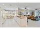 Bright, open-concept kitchen with granite countertops, ample cabinet space, and a sunlit dining area at 25559 Heritage Lake Blvd # 25, Punta Gorda, FL 33983