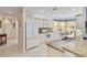 Bright kitchen featuring white cabinetry, granite countertops, and a cozy breakfast nook by the sunny windows at 25559 Heritage Lake Blvd # 25, Punta Gorda, FL 33983
