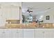 Open kitchen featuring granite countertops, a breakfast bar, and a view into the bright, inviting living area at 25559 Heritage Lake Blvd # 25, Punta Gorda, FL 33983