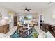 Charming living room with comfortable wicker furniture, stylish decor, and a serene water view at 25559 Heritage Lake Blvd # 25, Punta Gorda, FL 33983