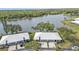 An aerial view of the residences with lush greenery and a serene lake in the background at 3106 Heron Shores Dr, Venice, FL 34293
