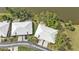 An aerial view shows homes with driveways and manicured lawns near the water at 3106 Heron Shores Dr, Venice, FL 34293