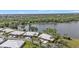 Scenic aerial view of a lakeside community with well-maintained lawns and beautiful landscaping at 3106 Heron Shores Dr, Venice, FL 34293