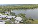 An aerial view of the residences, tile roofs, and the lake in the background at 3106 Heron Shores Dr, Venice, FL 34293