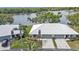 Close up aerial shot of residences with garages, lovely landscaping, and tile roofs at 3106 Heron Shores Dr, Venice, FL 34293