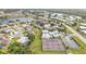 An aerial captures community amenities including tennis courts and a pool, nestled near peaceful homes at 3106 Heron Shores Dr, Venice, FL 34293