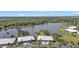 Aerial view of the home nestled between lush greenery and a serene lake at 3106 Heron Shores Dr, Venice, FL 34293