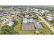 Aerial view features tennis courts, a pool, and residential areas nestled beside a lush green landscape at 3106 Heron Shores Dr, Venice, FL 34293