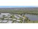 An aerial view of the residences and community, nestled between lush greenery and a serene lake at 3106 Heron Shores Dr, Venice, FL 34293