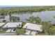 An aerial view of the residences with garages, lovely landscaping, and the lake in the background at 3106 Heron Shores Dr, Venice, FL 34293