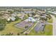 Beautiful aerial view features tennis courts, pool, and a picturesque community nestled around a serene lake at 3106 Heron Shores Dr, Venice, FL 34293