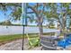 Backyard patio with colorful outdoor seating around a serene lake at 3106 Heron Shores Dr, Venice, FL 34293