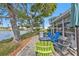 Backyard patio with colorful outdoor seating around a serene lake near a sunroom at 3106 Heron Shores Dr, Venice, FL 34293