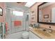 Bathroom featuring a shower with glass door, vanity, and soft peach-colored walls at 3106 Heron Shores Dr, Venice, FL 34293