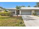 Charming single-story home featuring a well-maintained lawn and an attached two-car garage at 3106 Heron Shores Dr, Venice, FL 34293