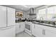 Bright kitchen with white cabinets, modern appliances, and a window view at 3106 Heron Shores Dr, Venice, FL 34293