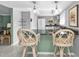 Bright kitchen featuring a breakfast bar with comfortable seating and stainless appliances at 3106 Heron Shores Dr, Venice, FL 34293