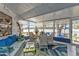 Sunroom with water views and white wicker furniture creating a relaxing atmosphere at 3106 Heron Shores Dr, Venice, FL 34293