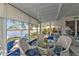 Sunroom with water views and white wicker furniture surrounding a glass-top table at 3106 Heron Shores Dr, Venice, FL 34293