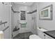 Shower featuring decorative tile, glass door, and black pebble tile floor at 3106 Heron Shores Dr, Venice, FL 34293