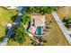 Aerial view of a home with screened pool, lush landscaping, and proximity to neighborhood amenities at 3123 David St, Punta Gorda, FL 33982