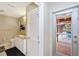 Bright bathroom with white cabinets, modern fixtures, and view to the inviting screened pool at 3123 David St, Punta Gorda, FL 33982