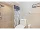 Bathroom featuring a tiled shower with decorative tile accents, toilet, and sign on wall at 3123 David St, Punta Gorda, FL 33982