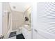 A well-lit bathroom with a vanity, toilet, and shower with tiled walls at 3123 David St, Punta Gorda, FL 33982