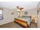 Cozy bedroom featuring a ceiling fan, a plush bed, and natural light from the windows at 3123 David St, Punta Gorda, FL 33982