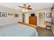 Comfortable bedroom featuring a wooden sleigh bed, ceiling fan, and a view of the ensuite bathroom at 3123 David St, Punta Gorda, FL 33982